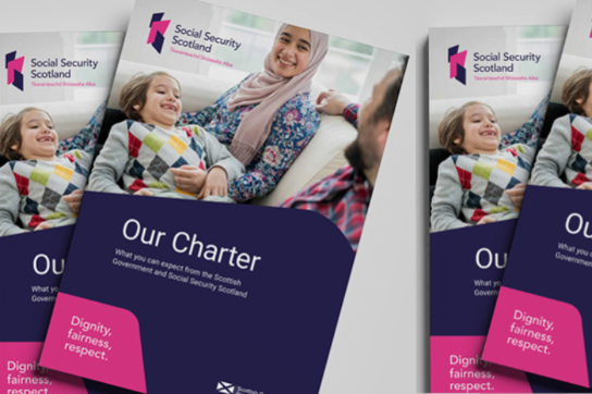 Copies of the Social Security Scotland charter sat on a table