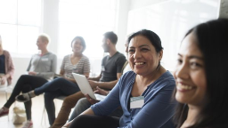 Group of people sitting in a circle, engaged in discussion.
