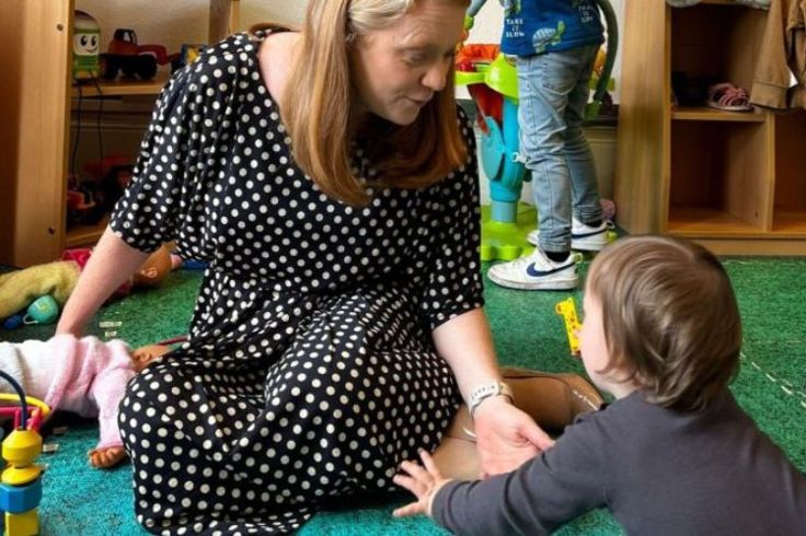 Cabinet Secretary for Social Justice, Shirley-Anne Sommerville sat on the floor playing with a child