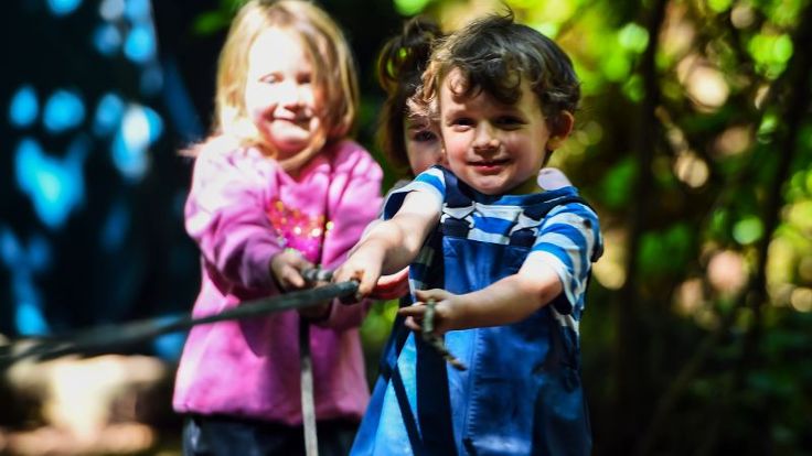 Two young children are playing outside
