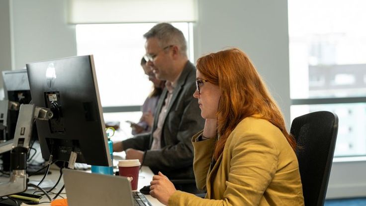 Colleagues sat at an office desk