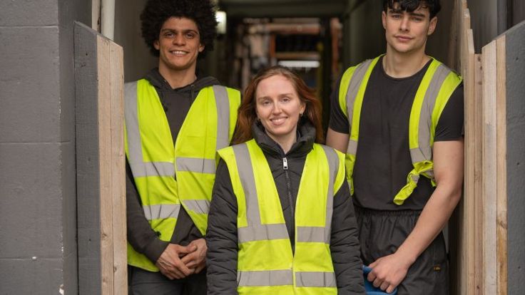 Three young people wearing high-vis vests