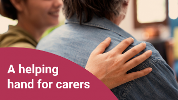 Two people with their backs toward the camera. One person has their hand on the other person's shoulder. The text overlay reads 'A helping hand for carers'