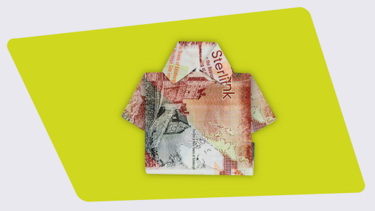 Scottish banknote folded into the shape of a shirt on a bright green background.