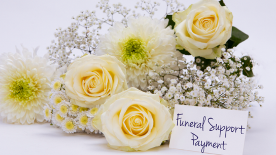 Bouquet of cream and white flowers with a card reading “Funeral Support Payment.