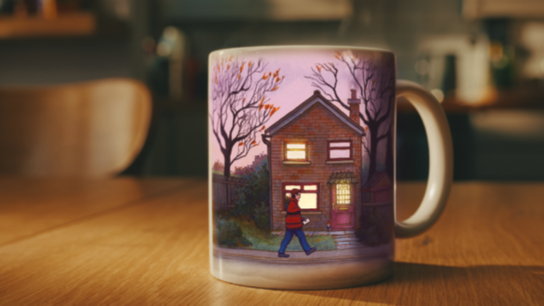Ceramic mug featuring an illustration of a house with lit windows and a person walking outside.