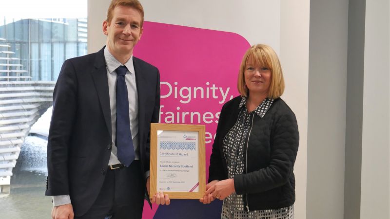 David Wallace receiving award from Sue McLintock