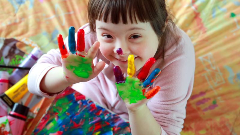 A child with paint on their hands