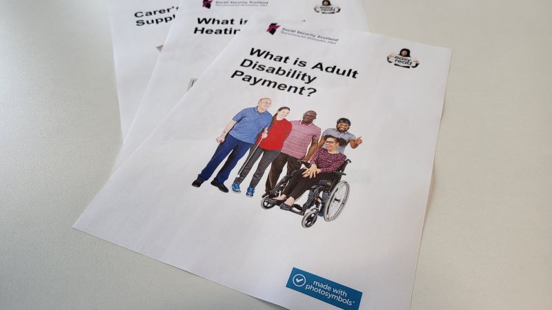 3 Social Security Scotland easy read factsheets sitting on a desk