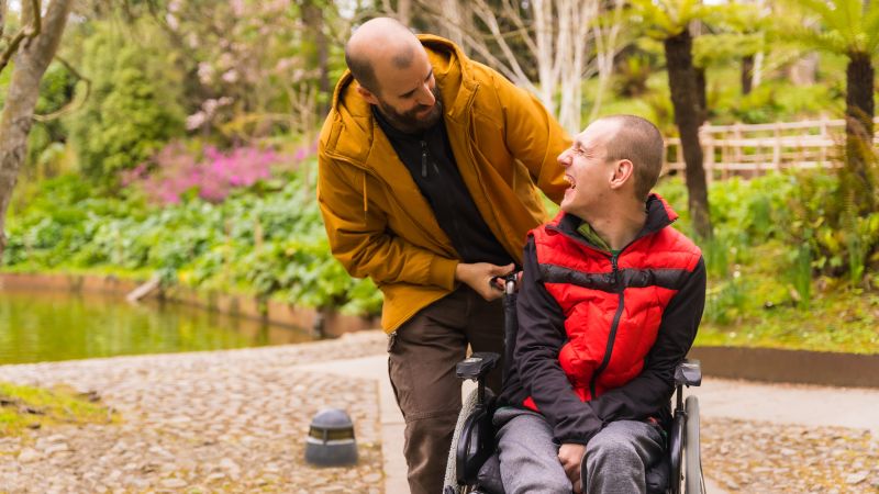 Carer with person in wheelchair.