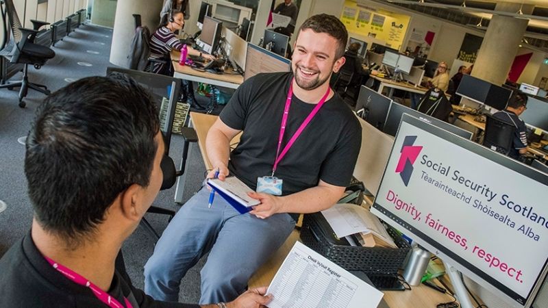 Colleagues talking to each other and smiling