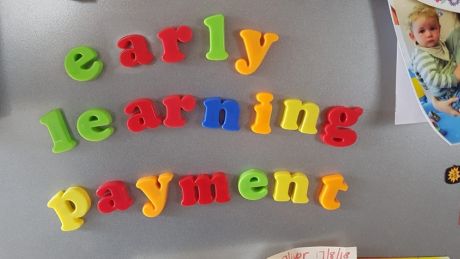 Early Learning Payment spelt with fridge magnets