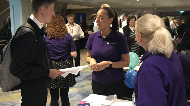 Social Security Scotland colleagues talking to a young man