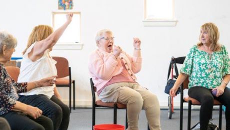 Elderly lady laughing in a group