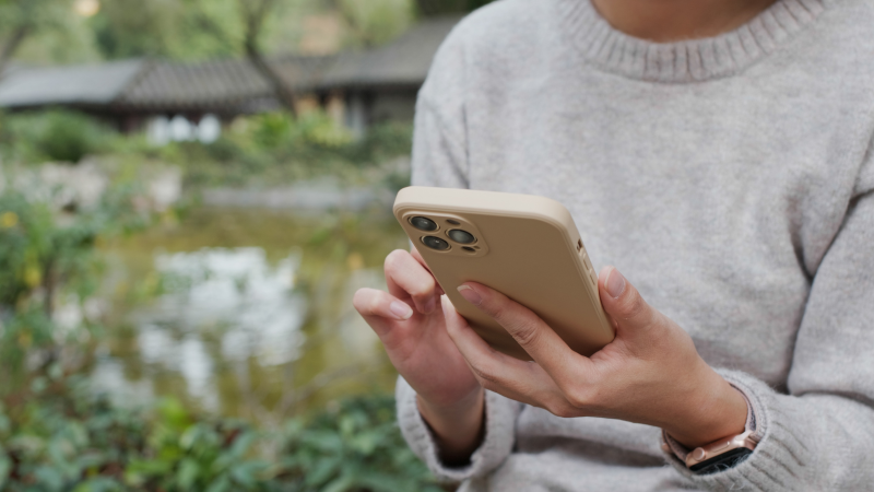 A person is using a mobile phone outside