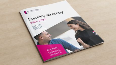 The Equality Strategy document is placed on a wooden table.