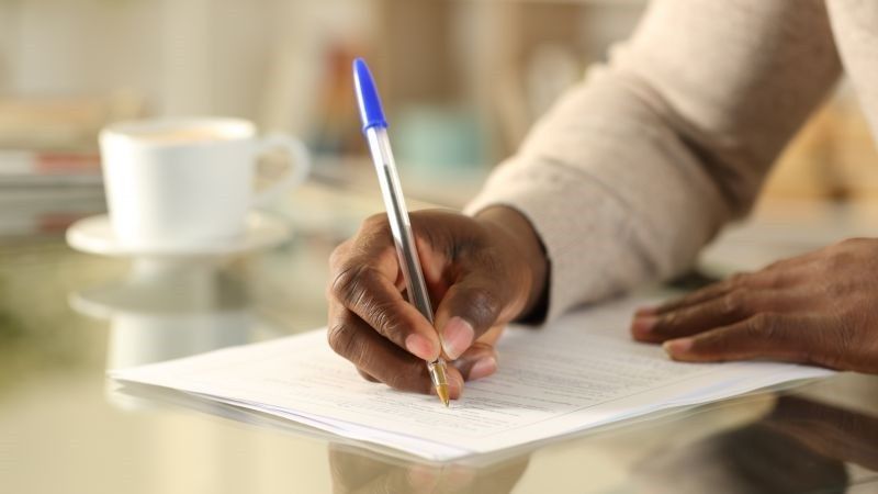 person writing on paper