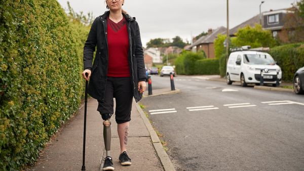A female walking with a walking stick